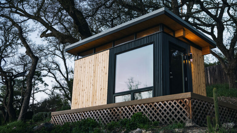 Compact shed cabin with wood and black exterior panels