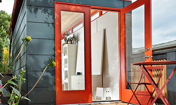 Small studio shed with red double doors open
