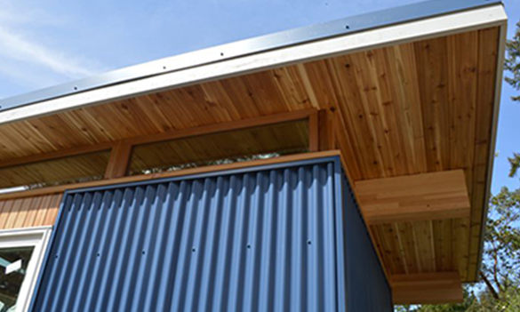 Contemporary shed roof detail with wood soffit and metal siding
