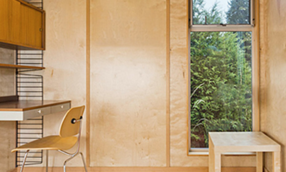 Minimalist shed interior with desk and tall window